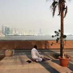 Man prays his Maghrib (sunset) prayer at the Palm Jumeira