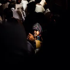 A little girl sitting with her father during a Majlis (4t