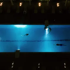 Hotel guests swimming at night, Dubai, UAE, 2015. iPhone 