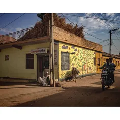 A man rests outside of a shop in Bhuj, Gujarat. Photo by 