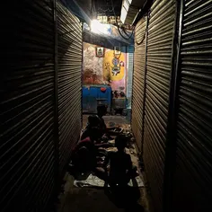 Indian children eat their dinner inside a closed commerci