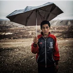 An Afghan boy in a poor neighbour of a city near Tehran. 