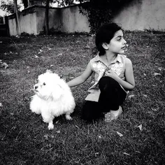 A girl whiles away the hours at a park along with her dog