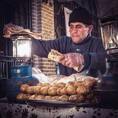 A vendor sells grilled potatoes (locally called Yeralma K