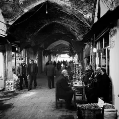 Men smoke Qalyan (hookah) at a traditional café in the Gr