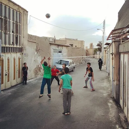 Boys playing volleyball on the street. Kashan, Isfahan, I