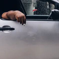 Smoker waiting in the car when the rain came as Singapore