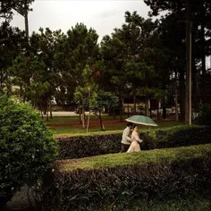 A couple walking in the gadren of cathedral of Da Lat for