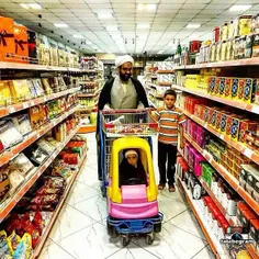 A Muslim clergyman shops around #Qom Hypermarket, along w