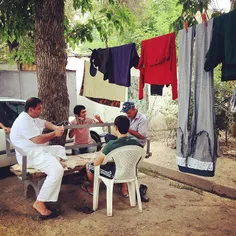 Dushanbe, July 16 th. Men and teenage boys play cards in 