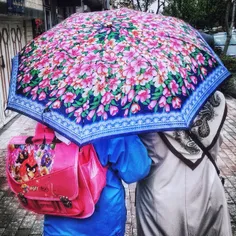 A mother walking in the street after picking her daughter